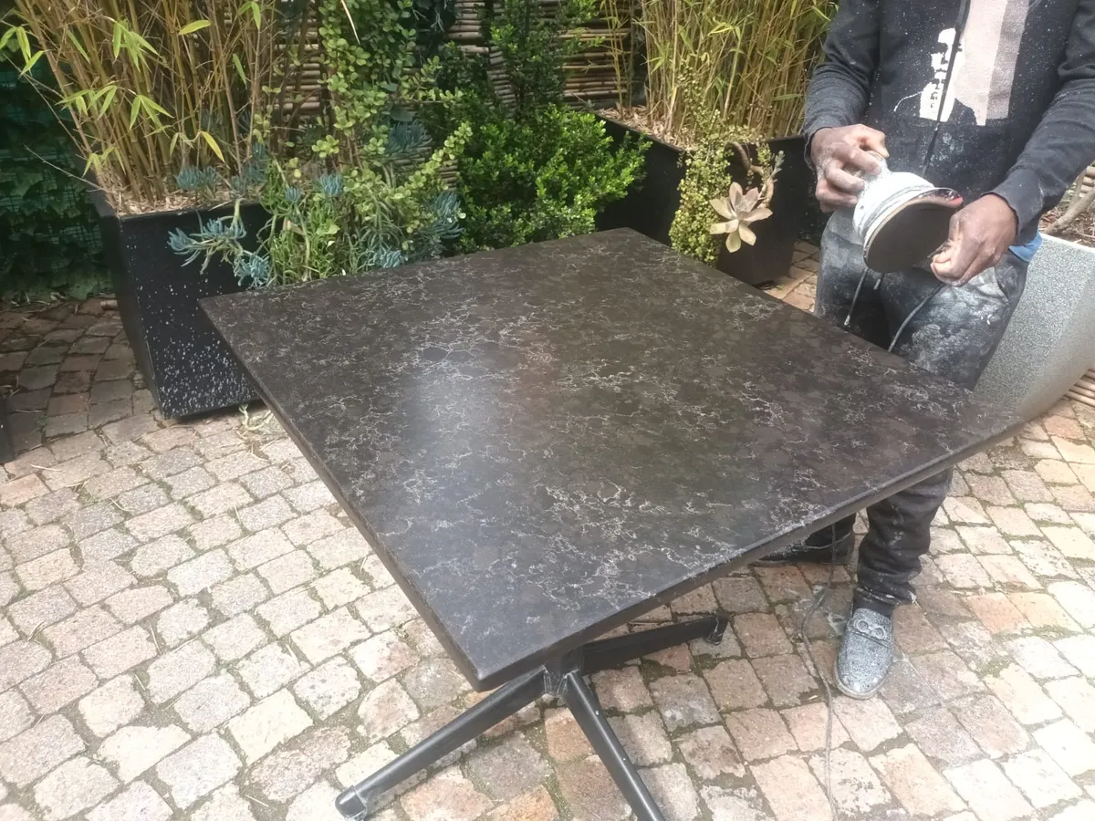 Dark veined stone outdoor table after restoration