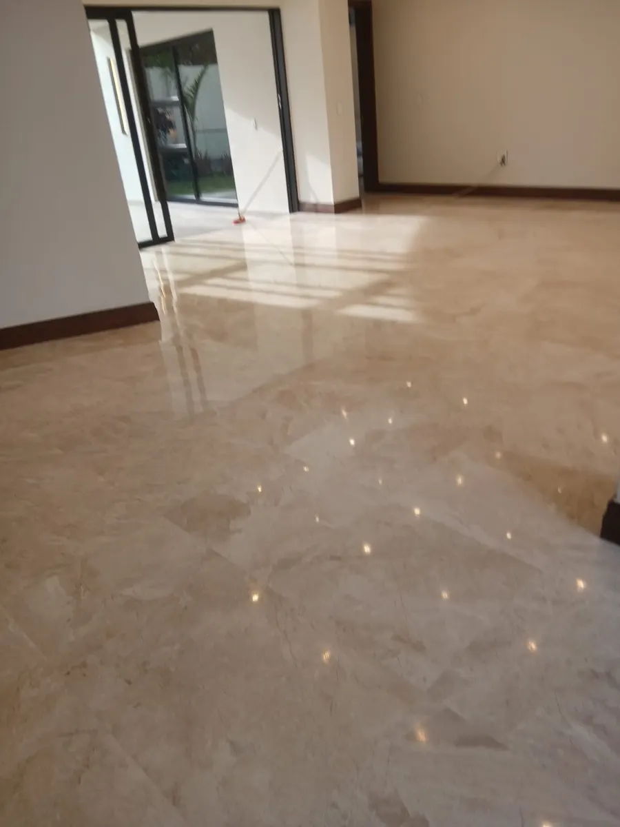 Polished marble floor reflecting the light from sliding doors