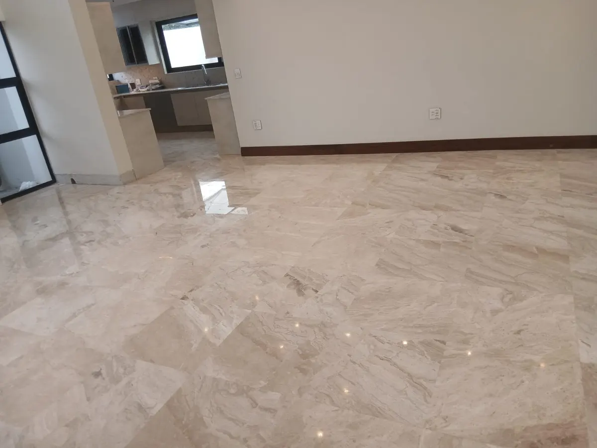 Polished cream marble tile floor in an open-plan room